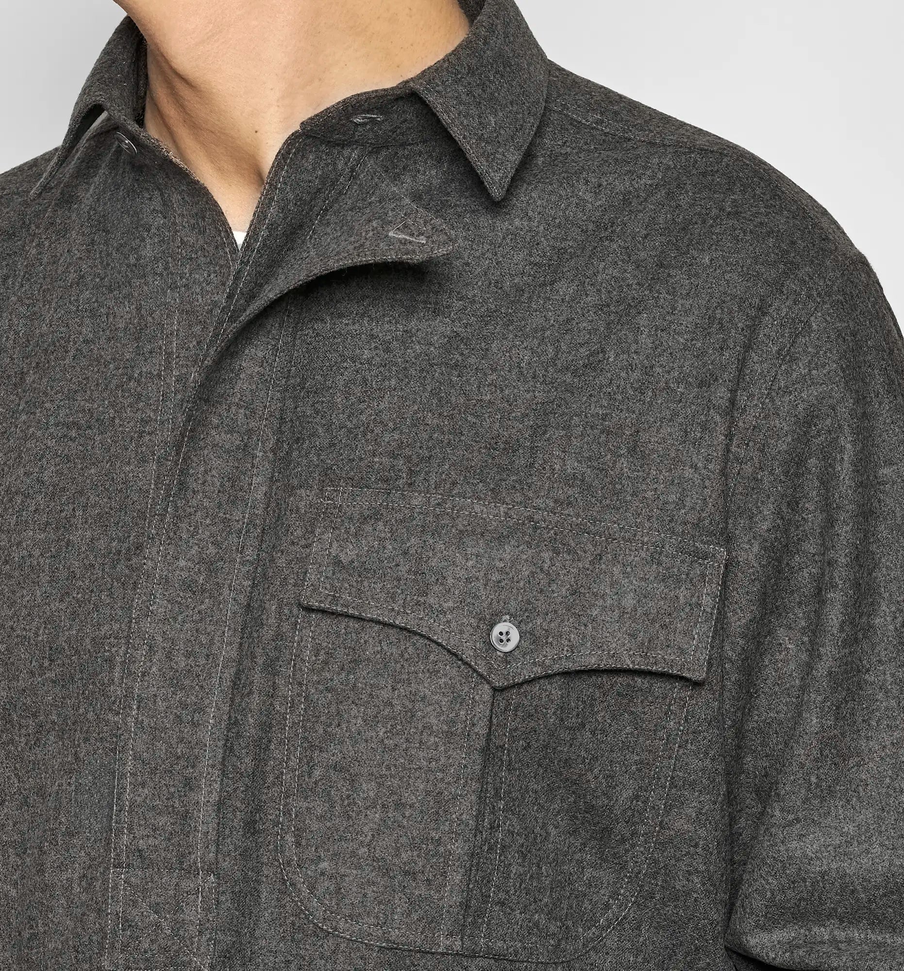 Detail view of the neckline of a charcoal gray Sébline shirt