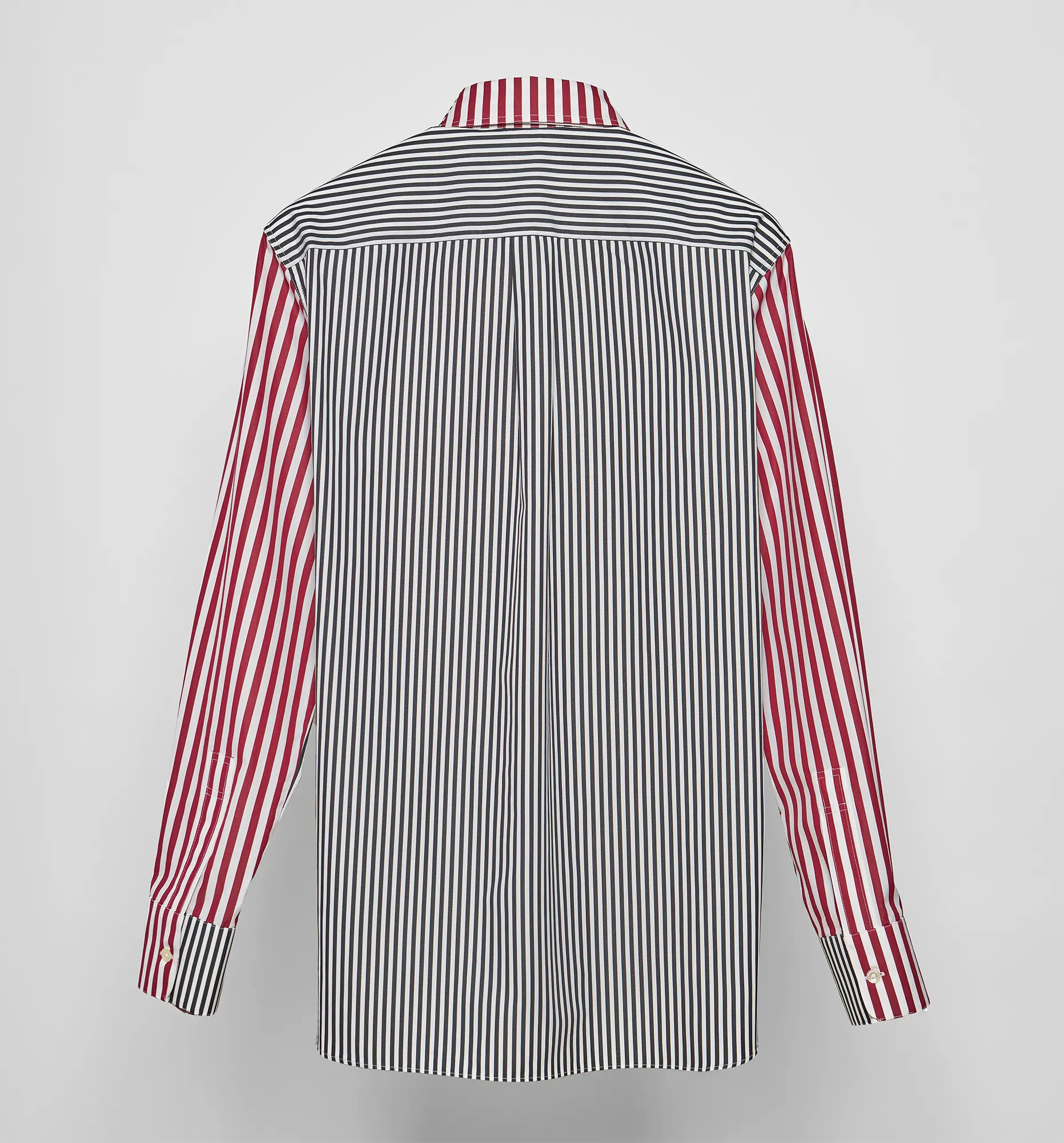 Striped shirt with red and black pattern on a light gray background