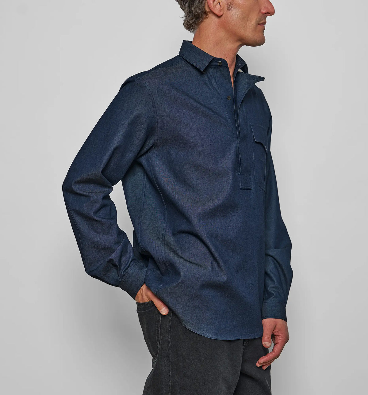 Combat Polo Shirt – Model wearing the denim twill pullover shirt, side view