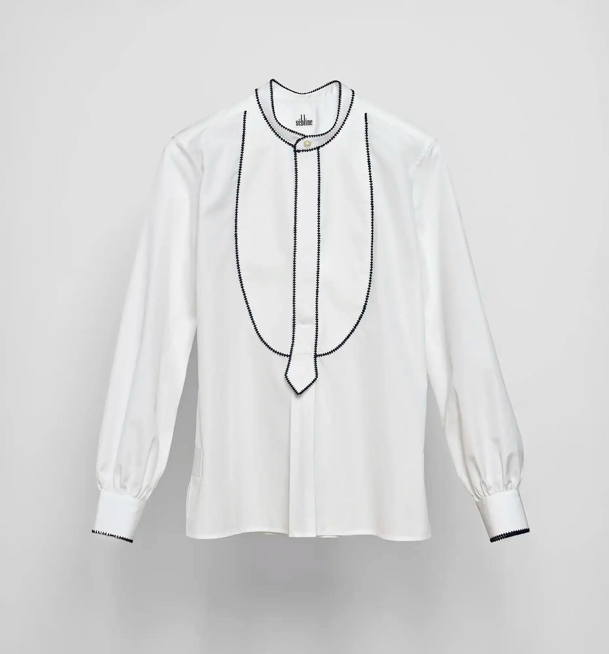 White cotton poplin pullover shirt with embroidered bib detail by Sébline, front view on neutral background.