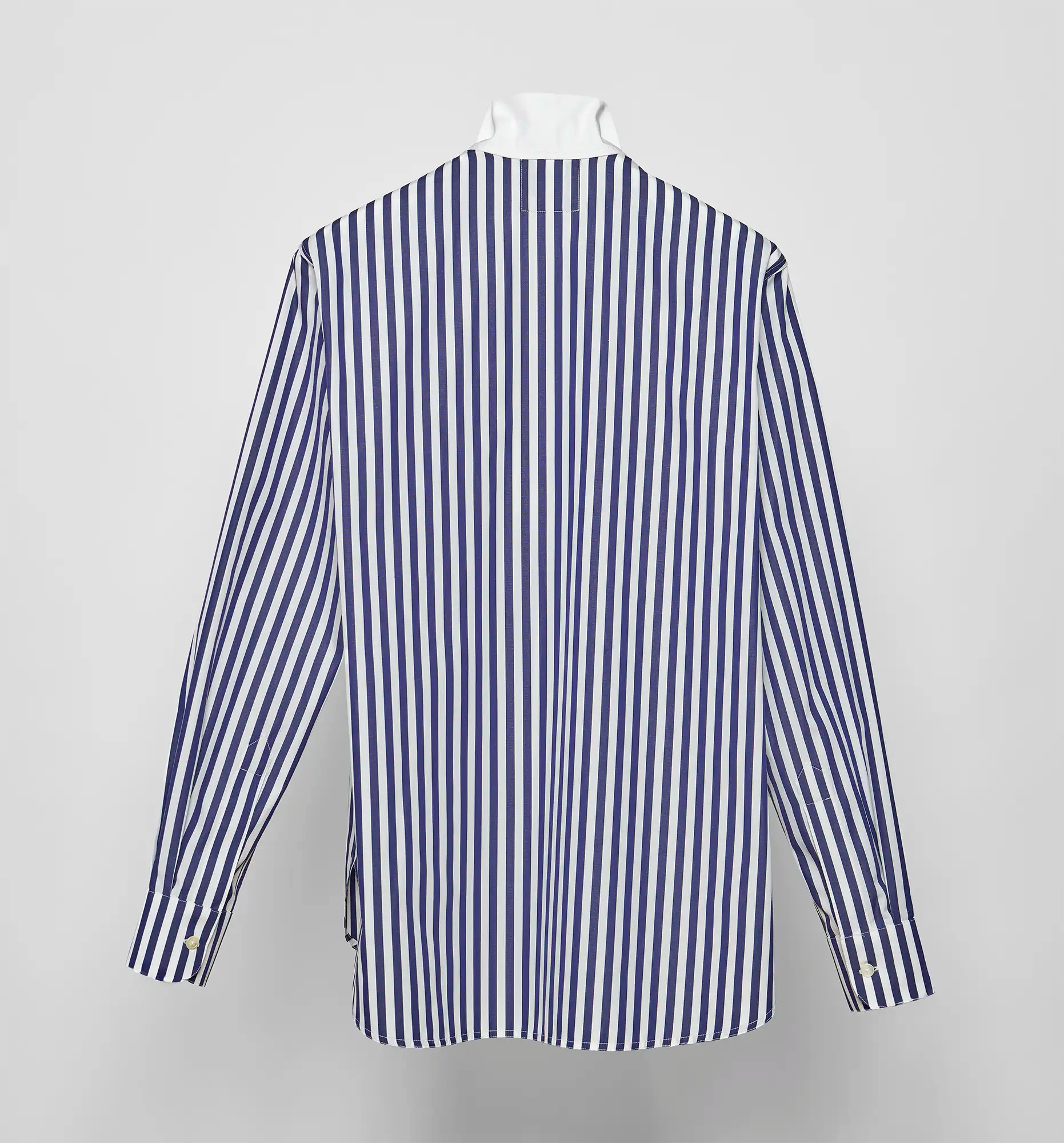 Back view of a navy and white striped Sébline shirt on a neutral background