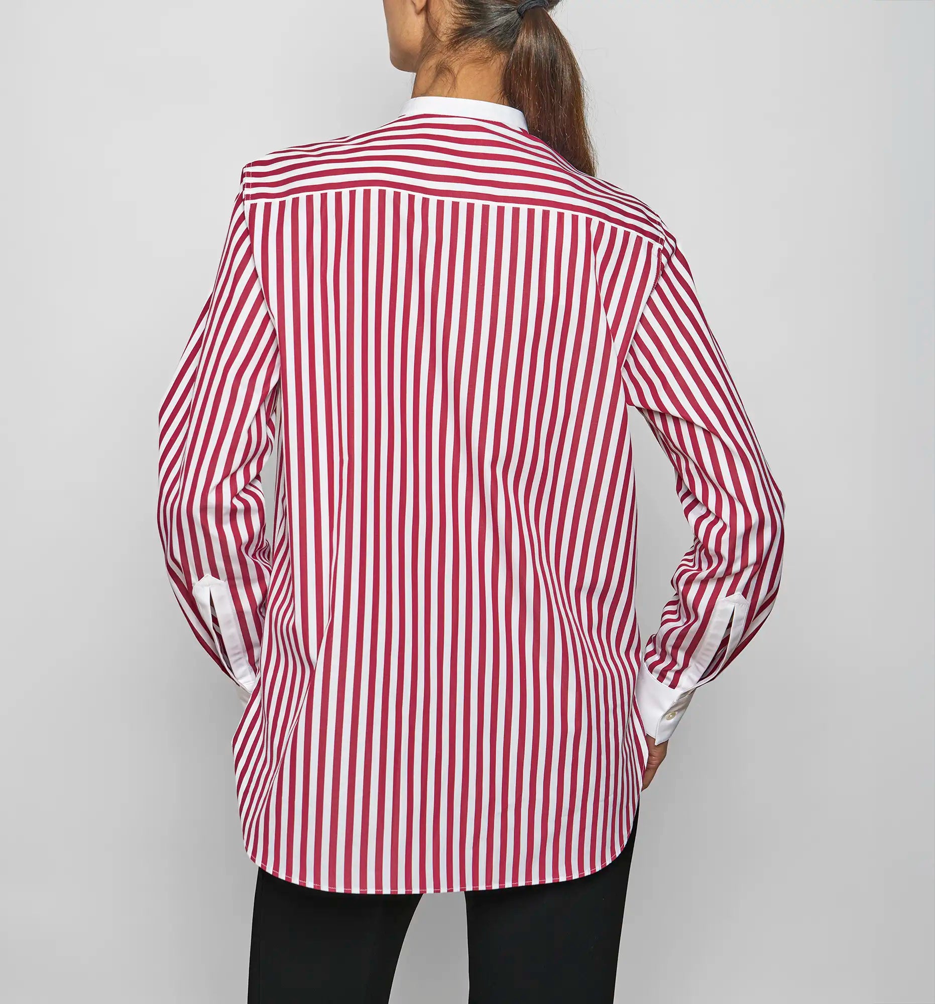 Model wearing a Sébline red-and-white striped long-sleeve shirt, back view.
