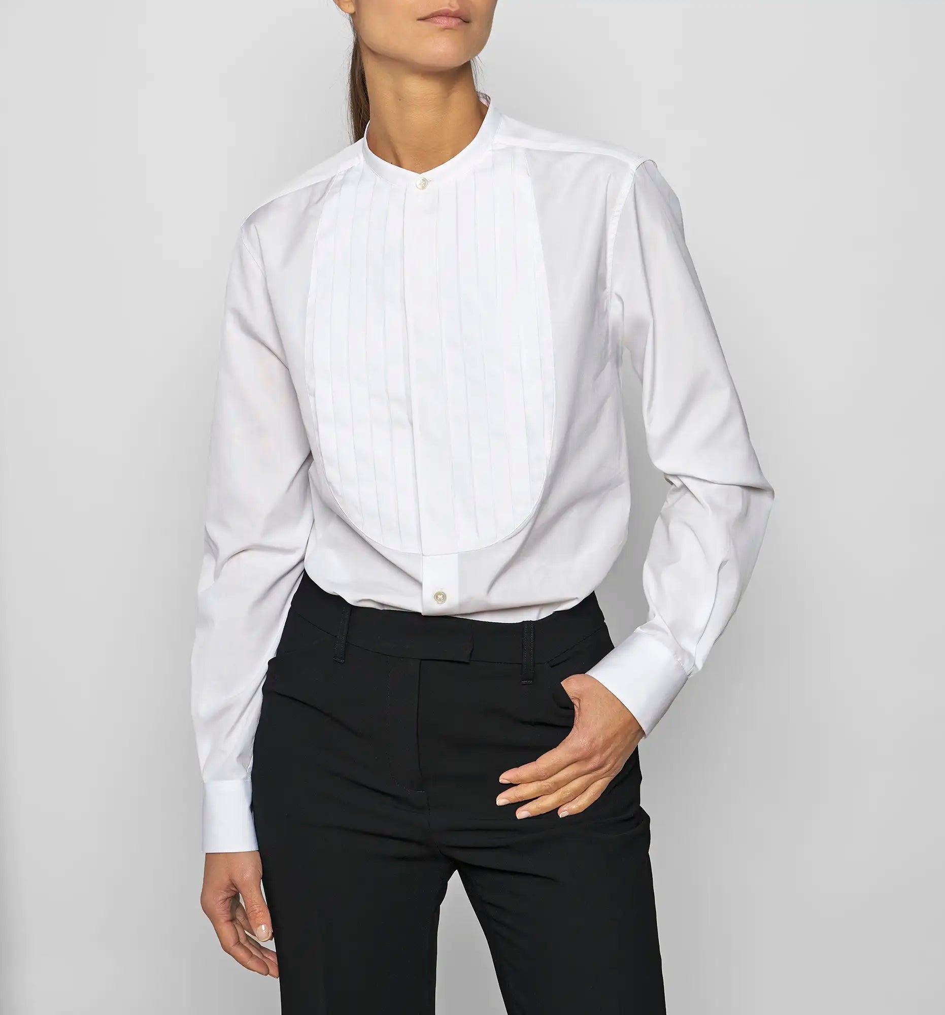 Model wearing a Sébline white long-sleeve shirt with pleated bib front panel, front view.