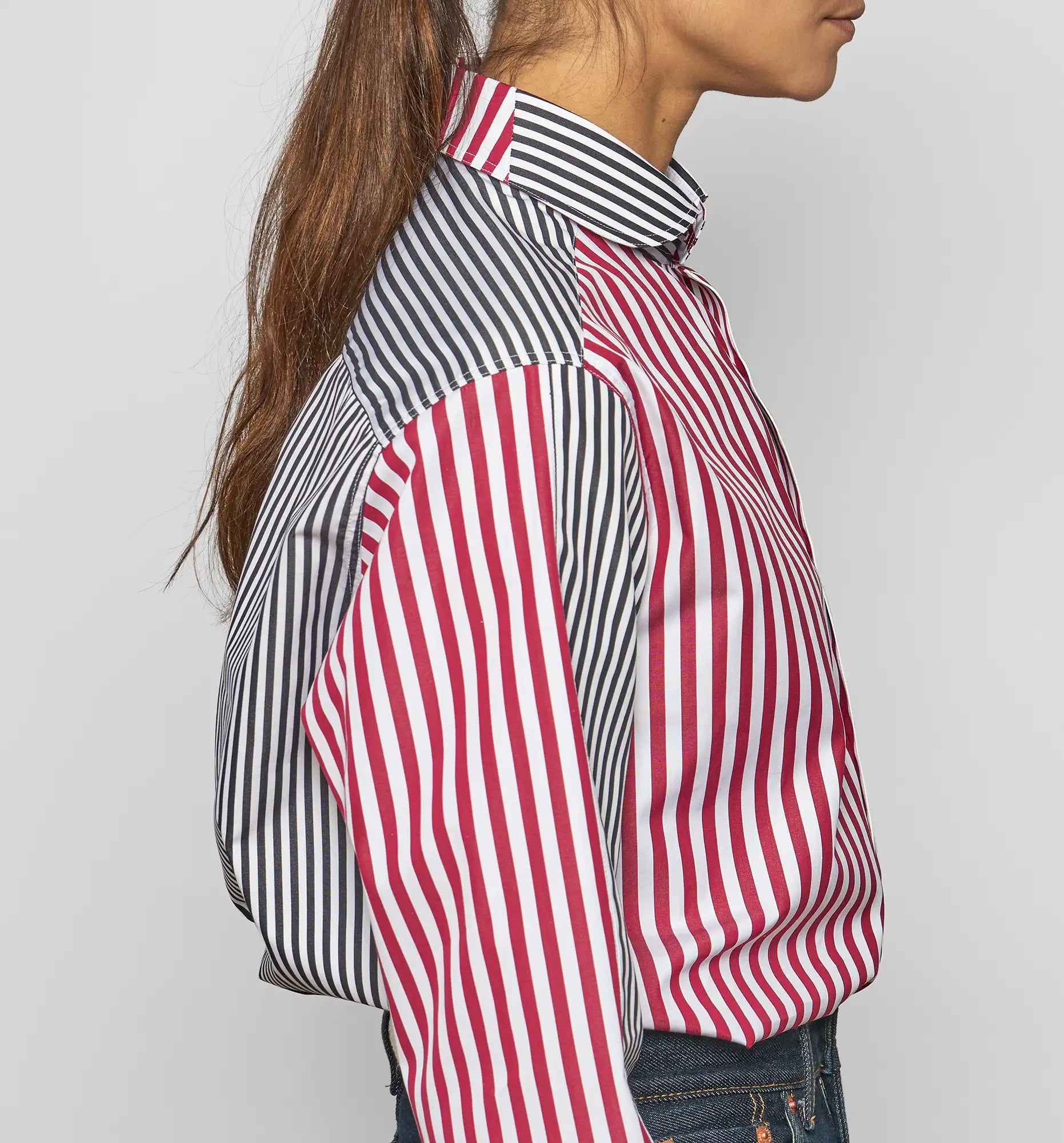 Side view of model wearing Sébline patchwork striped cotton poplin shirt.