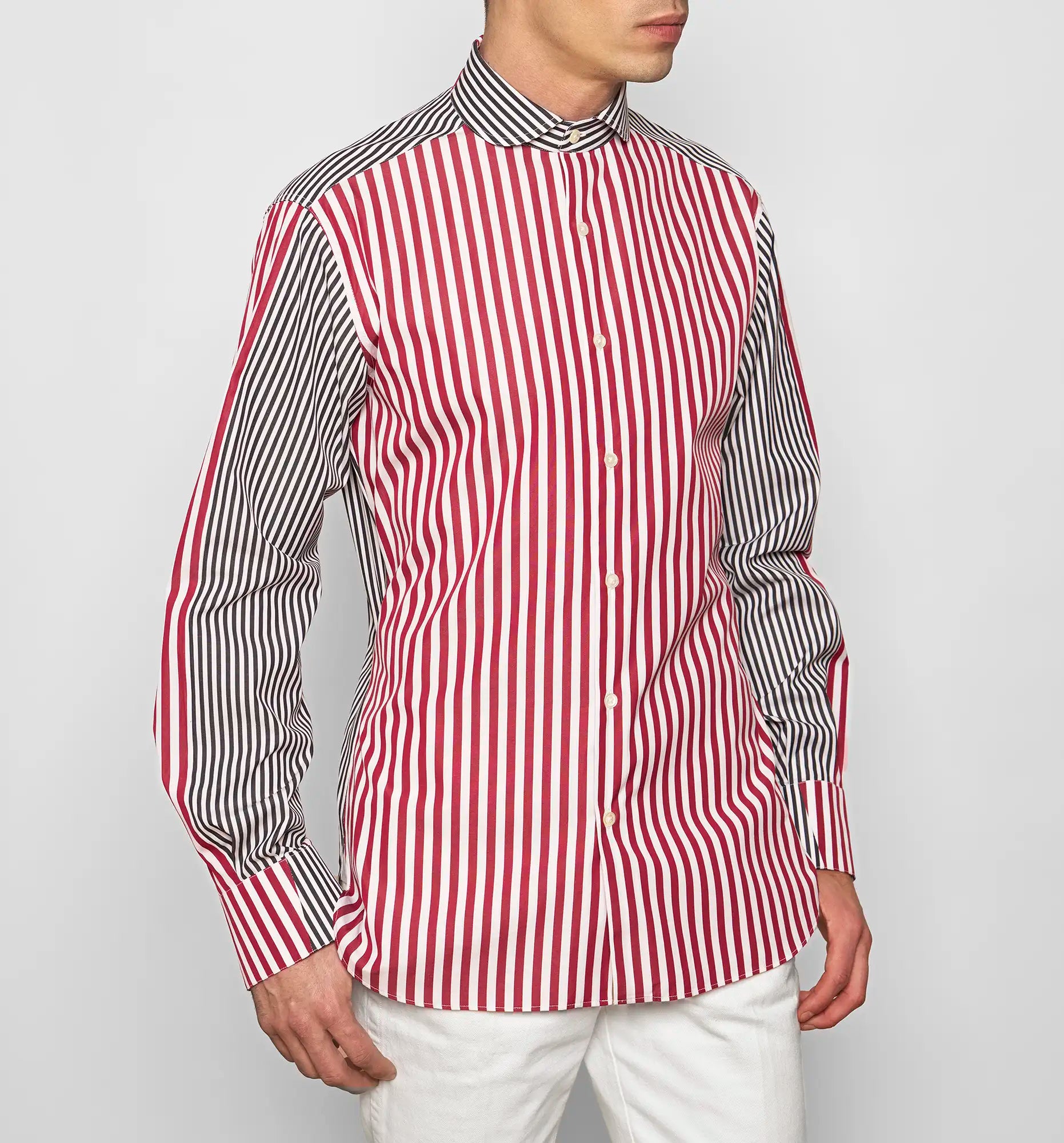 Red and white striped shirt with black and white patterned sleeves on a plain background