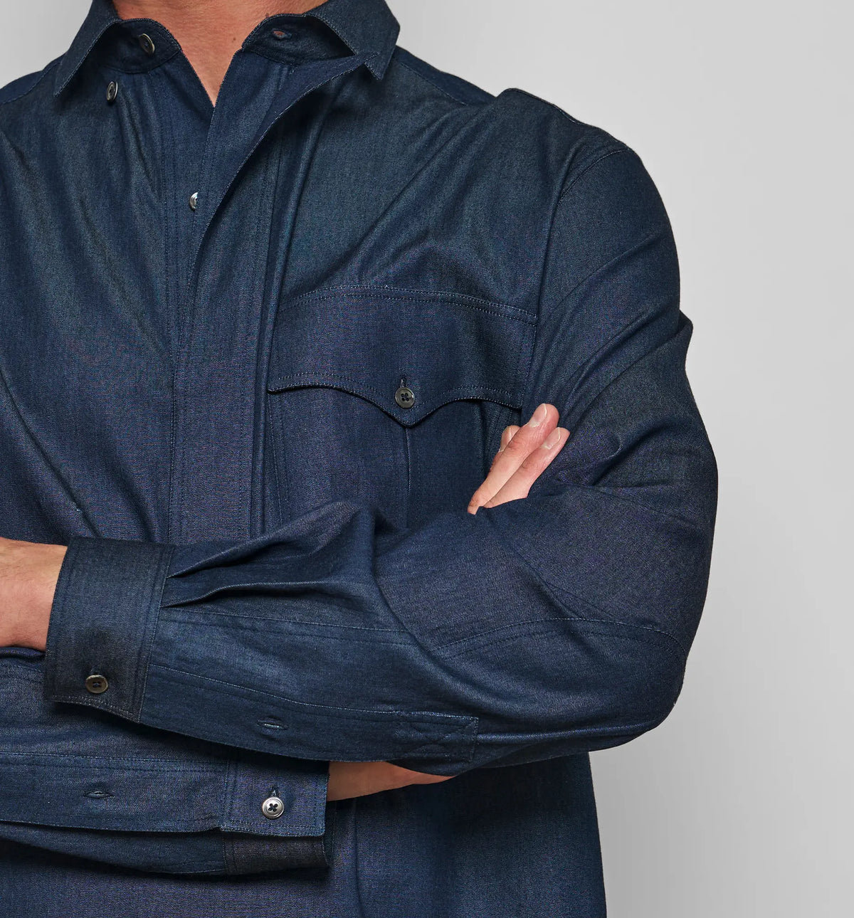 Combat Polo Shirt – Close-up of the front placket and chest pocket on the denim pullover shirt, worn