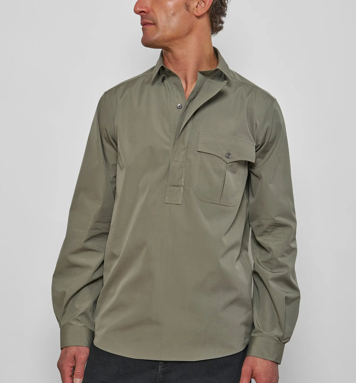 Men's Combat Polo Shirt – Model wearing the khaki asymmetric pullover shirt, front view