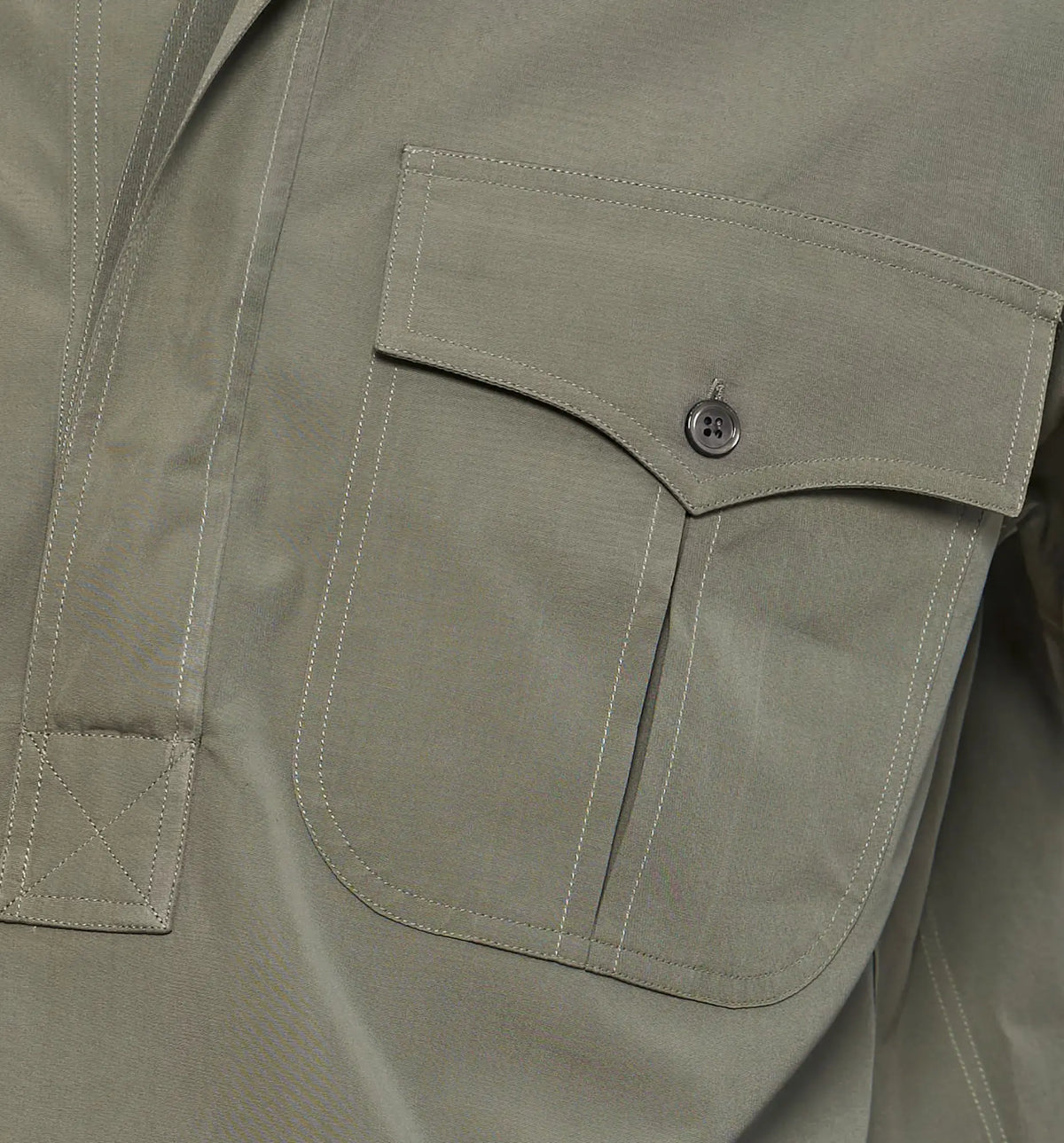 Combat Polo Shirt – Detail of the flap pocket on the khaki pullover shirt, flat lay