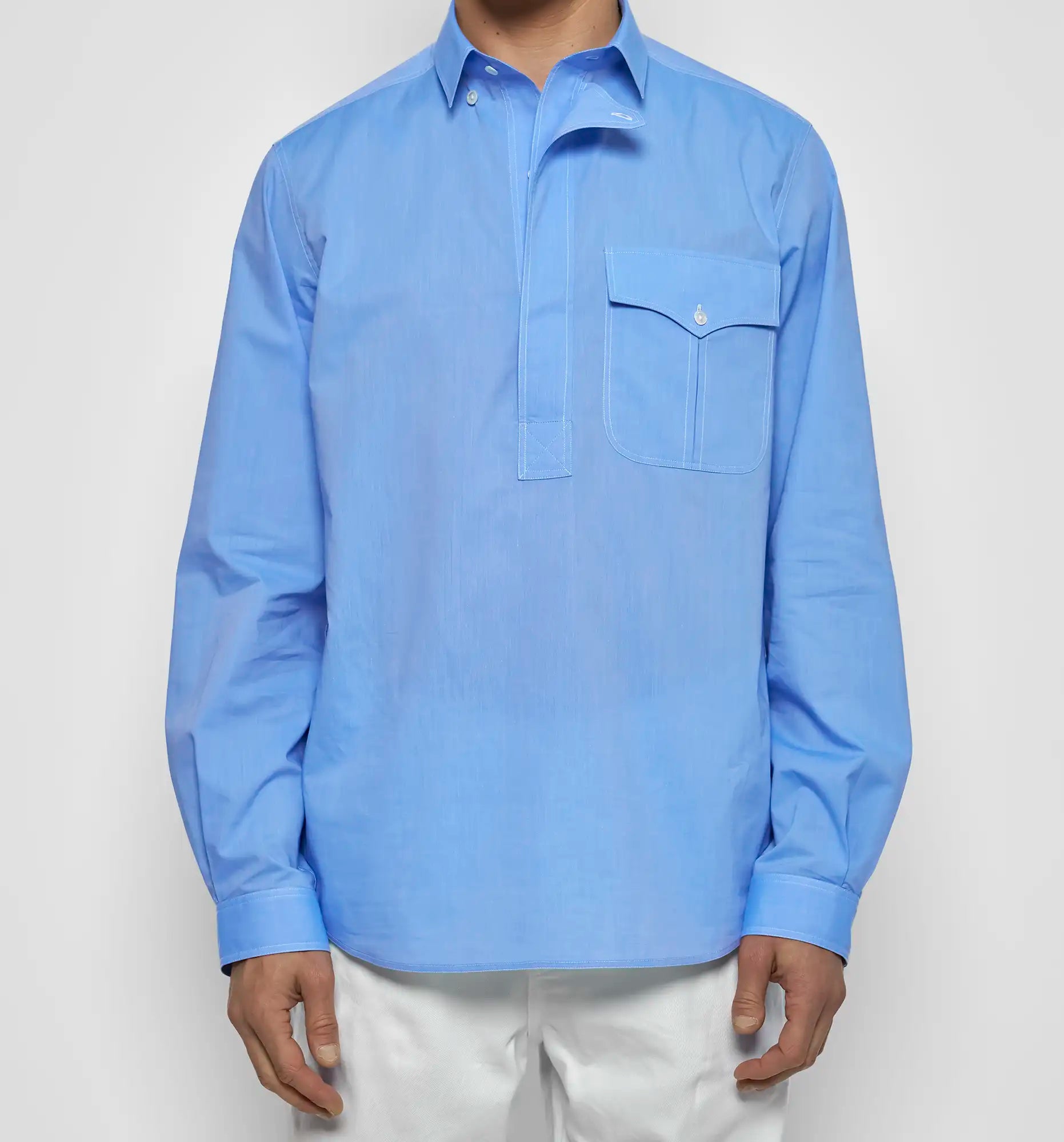 Light blue button-up Sébline shirt worn by a person on a white background