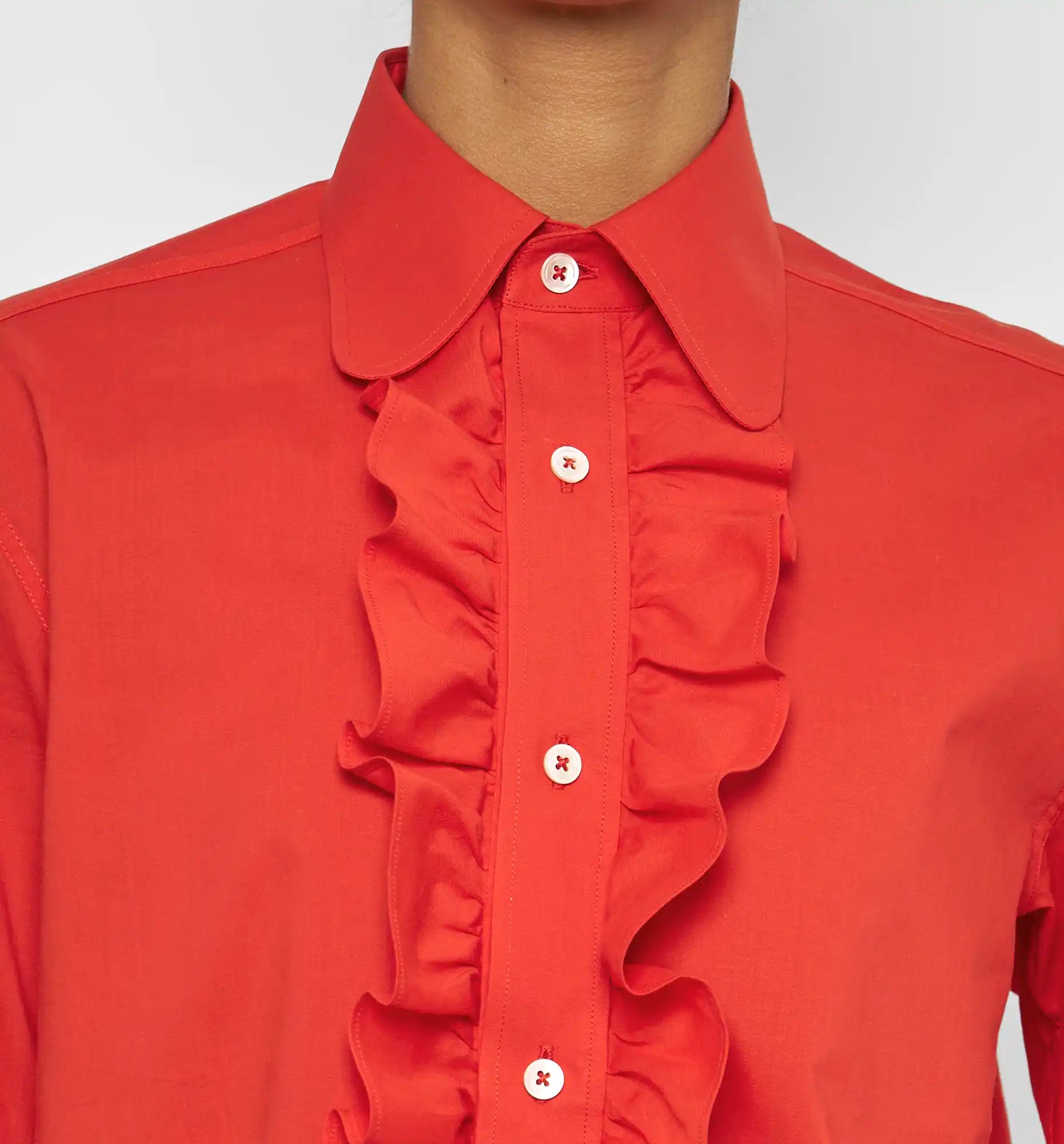 Ruffle polo shirt in poppy red — collar and ruffle detail