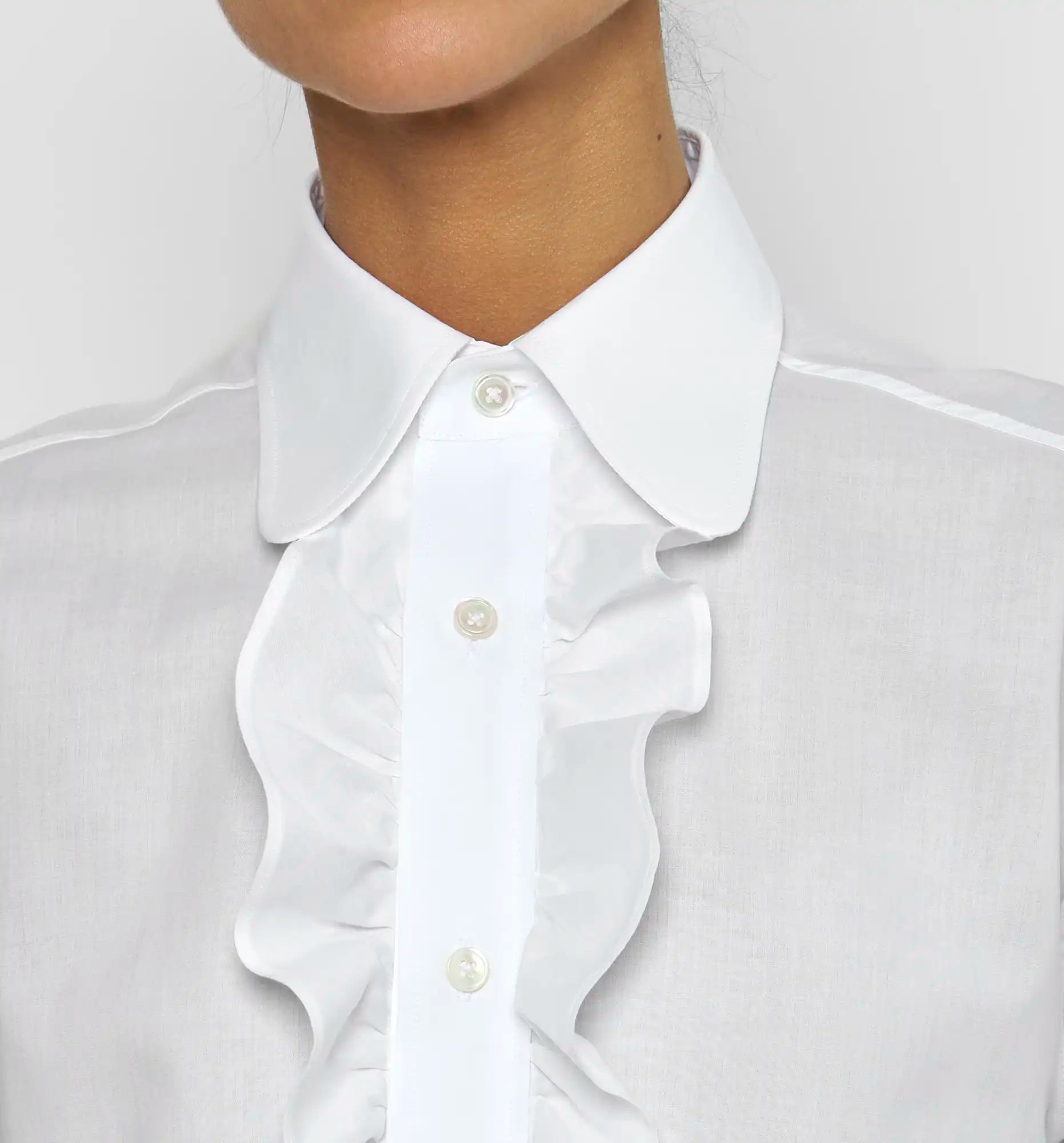 Ruffle polo shirt in white — collar and ruffle detail