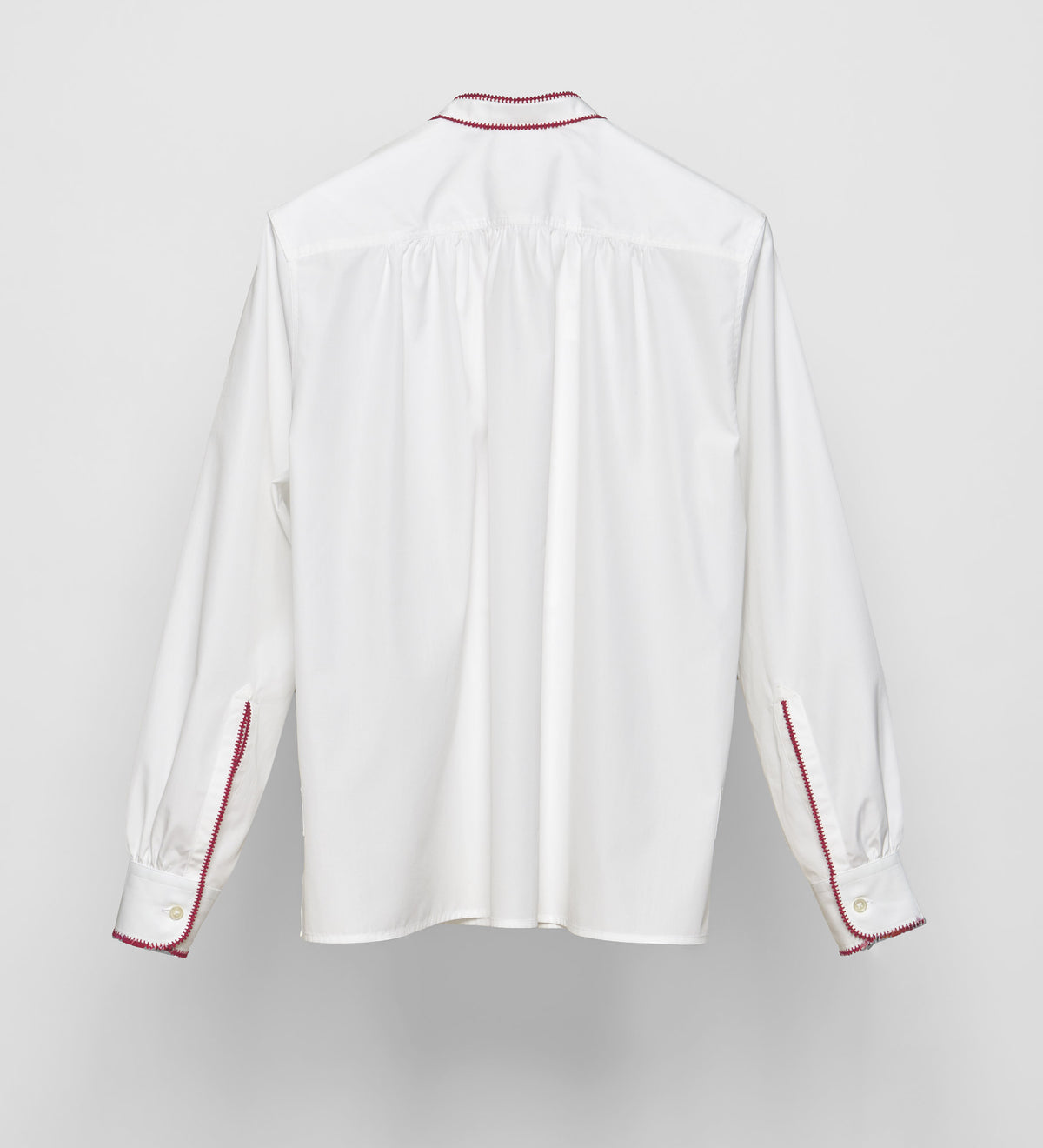 White cotton poplin pullover shirt by Sébline, back view on neutral background.